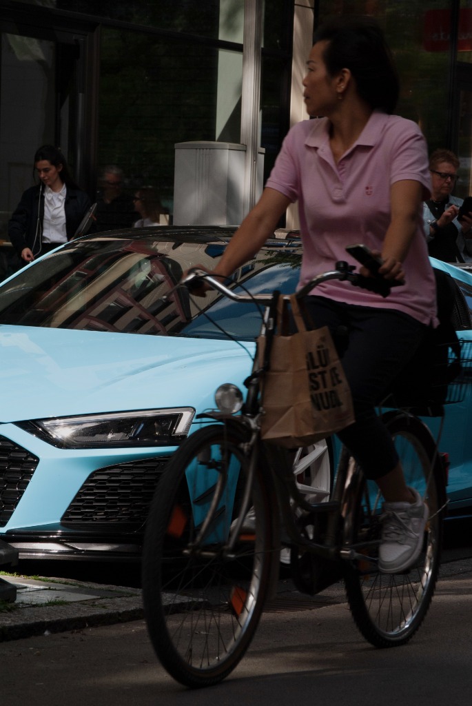 Blue Audi R8 supercar and cyclist street photography by Tony