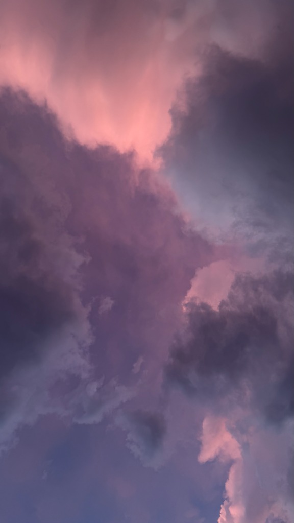 Violet pink clouds in twilight sky by Tony